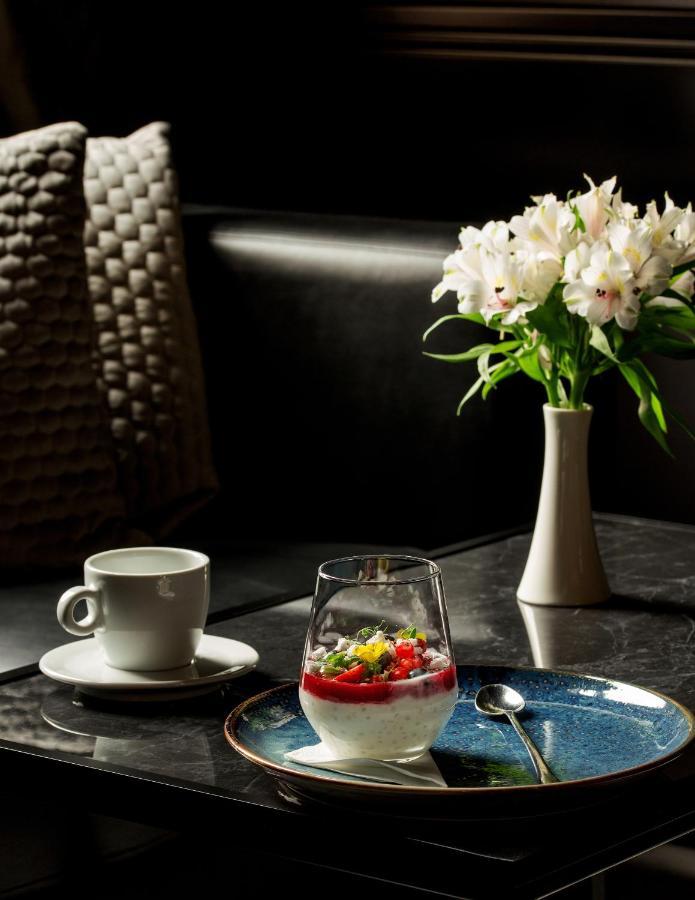 Platinum Palace Boutique Hotel & Spa Wroclaw Exterior photo A cup of coffee and a vase of flowers